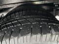 Close-up of a set of two heavily treaded tires from a 2019 Chevrolet Express showing detailed grooves and rubber texture