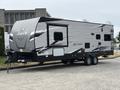 A 2021 Jayco Jay Flight travel trailer with a sleek silver exterior featuring black accents and a prominent Jayco logo on the front