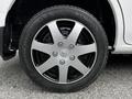 A close-up of a silver and black alloy wheel from a 2020 Nissan NV200 featuring five spokes and a Kumho tire
