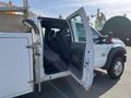 A 2015 Ford F-450 SD with its front door open revealing the gray interior and front seats