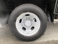 Close-up of a white wheel with lug nuts on a 2011 Dodge Ram 5500 tire