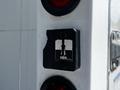 A metallic control box with an arrow pointing down and the word "Down" indicated on it