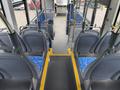 Interior view of a 2018 Grande West Vicinity bus showing rows of blue patterned seats and an aisle leading to the driver's area