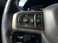 Close-up of a steering wheel control panel from a 2019 RAM 1500 featuring buttons for navigation phone and voice control