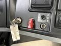 Close-up of the dashboard controls in a 2013 International 4300 featuring a red shut down switch a key ignition and a toggle switch labeled INT and EXT
