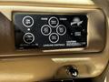 A control panel for leveling a 2000 Ford Motorhome featuring buttons for retracting and raising jacks with labeled functions for front rear and left right jacks