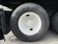 Close-up of a Goodyear tire mounted on a white wheel of a 2016 International 7600 with visible tread and manufacturing details
