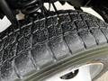 Close-up of a tire tread from a 2017 Ford F-550 showcasing deep grooves and textures indicating wear and grip
