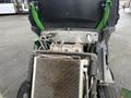 A 2014 John Deere 1585 Terrain Cut with an open engine compartment showing the engine components and radiator system