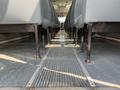 Interior view showing rows of gray bus seats and a rubberized floor in a 2007 Blue Bird Vision with a center aisle visible