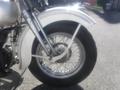 1947 Harley-Davidson WL featuring a front wheel with a wire spoke rim and a white fender