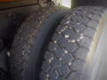 Close-up of two large, rugged tires on a vehicle with a tread design suitable for heavy-duty use