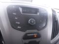 Dashboard controls of a 2016 Ford Transit featuring radio buttons volume knob and passenger airbag indicator light