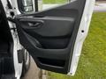 A 2021 Mercedes-Benz Sprinter van door interior featuring a sleek design with handle and window controls