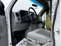 Interior view of a 2016 Ford Econoline with a driver's seat and dashboard visible along with part of the steering wheel and control panel