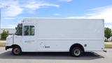 A white 2011 Ford Econoline delivery van with a boxy shape and no visible markings on the side