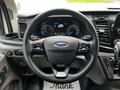Steering wheel of a 2023 Ford Transit with dashboard display showing speed and fuel indicators