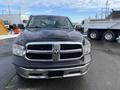 A 2015 RAM 1500 pickup truck with a black exterior and chrome grille facing the viewer