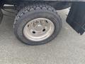 Close-up of a 2017 Ford F-550 tire showcasing a shiny silver wheel with a rugged tread pattern