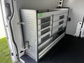 A silver storage system with multiple drawers is installed inside a 2017 Mercedes-Benz Sprinter van