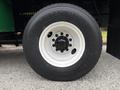 Close-up of a white wheel from a 2015 Freightliner M2 106 featuring a black tire with the Continental HDG tire brand name visible on the sidewall