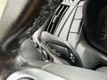 A close-up view of the steering wheel controls of a 2017 Ford Transit showing indicators and various buttons