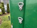 Two silver latches are mounted on a green container's door