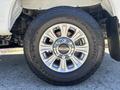 Close-up of a 2020 Ford F-350 SD wheel featuring a silver aluminum alloy rim with a center cap displaying the Ford logo and a Bridgestone Dueler AT tire