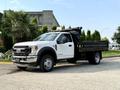 A 2022 Ford F-550 truck with a flatbed design parked on a paved area