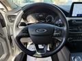 A 2020 Ford Escape steering wheel with controls and the Ford logo visible in the center