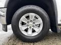 A close-up of a silver wheel and tire from a 2015 GMC Sierra 1500 showcasing the detailed alloy rim and large all-terrain tire with the Scorpion ATR branding