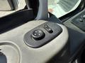 A close-up view of the control panel in a 2009 International 7500 featuring two circular buttons with directional arrows and an additional round control knob
