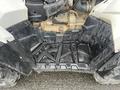 2017 Polaris Scrambler with a black textured floor panel featuring grooves and compartments for storage