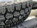 Close-up of a heavy-duty tire showing detailed tread patterns and robust sidewalls designed for a 2024 Ford F-550