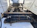 A partially visible loading platform of a 2007 International 7300 truck showing rust on metal components and support beams