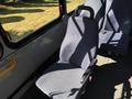 A blue fabric seat with a black armrest inside a 2017 Chevrolet Express van