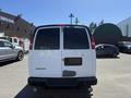 A white 2007 Chevrolet Express van is parked with its rear facing the viewer and the windows are tinted