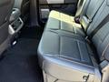 Interior view of a 2024 Ford F-550 Super Duty showing the rear seating area with leather upholstery and seat belts