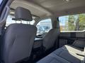 Interior of a 2017 Ford F-350 SD showing rear seats and center console with gray upholstery