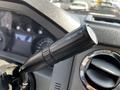 Close-up of the tow/haul mode switch in a 2016 Ford F-550 interior with a black textured handle and marked text on the side