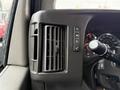 Close-up of the dashboard controls and air vent in a 2020 Chevrolet Express featuring buttons for hazards and traction control