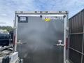 A gray 2020 Stealth Enterprises trailer with a logo and a license plate on the rear doors