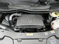 The image shows the engine compartment of a 2023 Mercedes-Benz Metris with the engine cover prominently displayed and various mechanical components visible