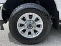 Close-up of a 2020 Ford F-350 Super Duty wheel featuring a shiny chrome rim and a rugged tire with deep treads
