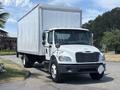 A white 2015 Freightliner M2 106 box truck with a silver cargo area and a front cab featuring headlights and side mirrors