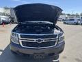 A 2016 Chevrolet Tahoe with the hood open, displaying the engine compartment and front grille with the Chevrolet logo
