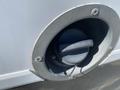 Close-up of the fuel cap of a 2020 Chevrolet Express with a twist-off design and a label that reads "TIGHTEN UNTIL ONE CLICK"