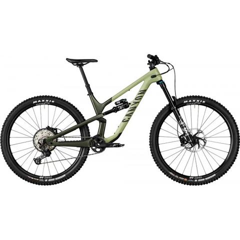 2024 Canyon Spectral 29 CF 7 Mountain Bike with a greenish frame featuring wide tires a dropper seat post and a front suspension fork