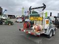 A 2011 Hightliner Aquacide Hot Water Weed Control Dual Flat Deck Trailer with reels and a warning sign indicating to stay back 15 meters