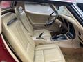 Interior view of a 1970 Chevrolet Corvette featuring tan leather seats and a detailed dashboard with gear shifter and controls.